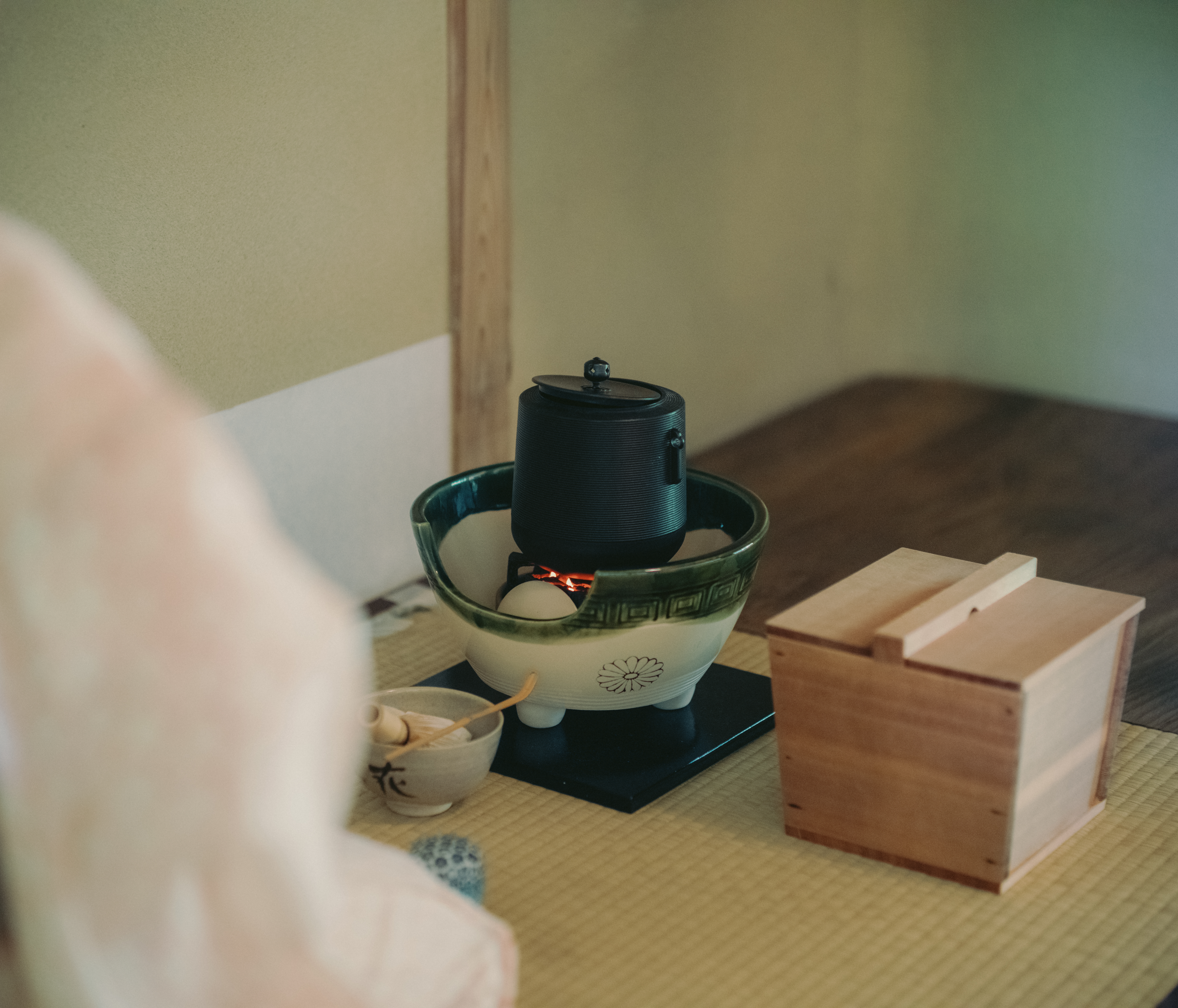 A quiet tearoom — steam rising, tatami underfoot